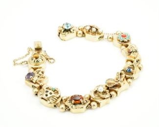 14k Gold slide bracelet with citrine, sapphire, aquamarine, turquoise, coral, emerald, amethyst, tiger eye, pearl & diamonds.  There are a few little turquoise pieces missing.