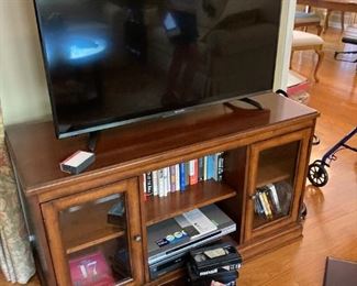 TV    cabinet with glass doors    books