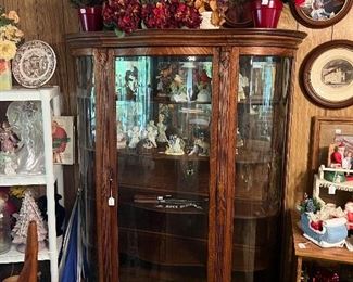 Antique curio cabinet with wooden shelves