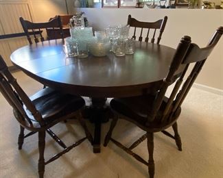 Dining table 4 chairs shown with one leaf already in table