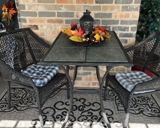 woven patio chairs and metal table