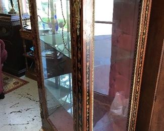 Beautiful neo classical Display cabinet 5'X3'. Notice the application of metal/brass trim and beautiful flower motif. Late 1800's early 1900's. Glass shelves. Tufted backdrop. Wiring for light needs to be redone.