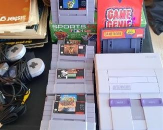 Vinatage Super Nintendo with games and a Game Genie