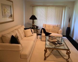 Another room with a Stanley white sofa and chair and an iron glass top coffee & end table
