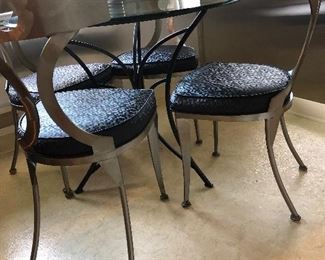 Modern glass top kitchen bistro table and four steel chairs