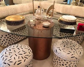 Corner glass top table on a laminate base with two short stools, the benches are built into the house and are not for sale