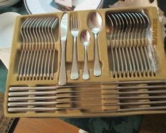 Stainless flatware set - new in case.  Service for 12.  Serving pieces in next pic.  Cannot read imprinted name.  Probably Japan.