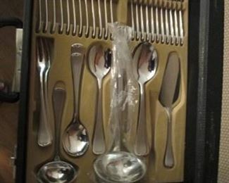 Serving pieces for stainless flatware set.  Cannot read name. 