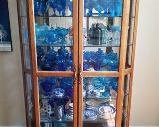Beautiful china cabinet filled with blue glass 