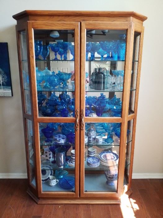 Beautiful china cabinet filled with blue glass 