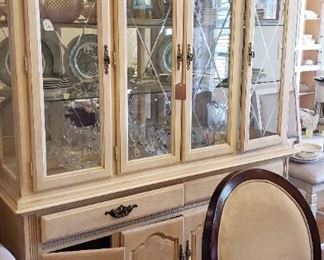 Whitewashed china cabinet, 6 neutral upholstered chairs, dining table