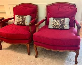 Pair of Formal Upholstered Arm Chairs by Baker in a beautiful hue of read. Measuring about 28" arm to arm, 33.5" overall height and 24" x 29" seat measurements. 