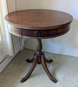 Vintage Claw Foot Drum Table. There are some light scratches and the top is loose, but can easily be tightened. Measures 25” in diameter and 27.5” high.
