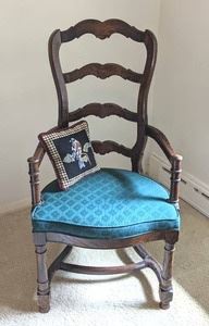 Ladder Back Armchair. The upholstery is more green than it appears in the photos. Includes the adorable pillow!

Measures 23” wide, 18” deep, 18” high to the seat and 42” high to the chair back.