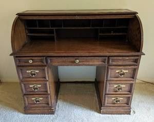 Sligh Roll Top Desk. There are some scratches/nicks that can be seen in the photos. Measures 46” wide, 23” deep and 40” high