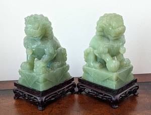 Pair of Carved Jade Foo Dog Figurines. Each measures 6.5” high and 4” x 3” at the base.