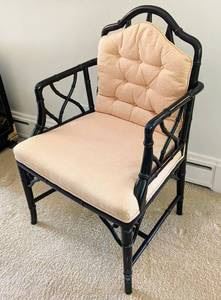 Black Bamboo Style Armchair. There is a small spot on the seat and unknown if removable with cleaning. Measures 22” wide, 19” deep, 18” high to the seat and 36” high to the chair back.