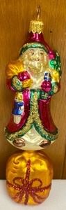 Christopher Radko Santa on a Present Ornament measures 7 inches tall.