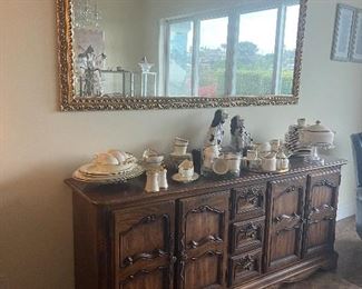 Buffet with two double door cabinets with 3 drawers in the center.