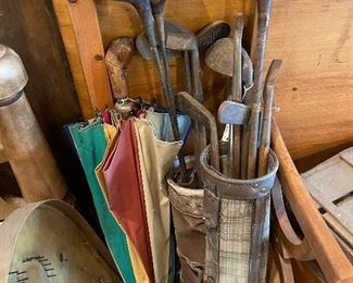 Antique golf clubs and umbrella