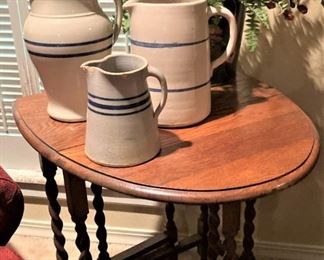 Small barley twist dropleaf table; pottery pitchers