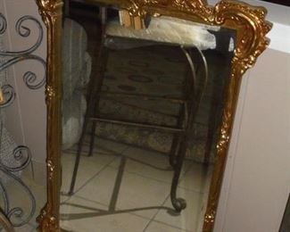 Gold ornate framed beveled mirror