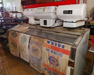 Vintage porcelain scales, seed sacks, and deep freezer display. 