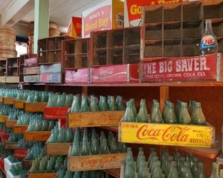 Thousands of soda bottles including Coca Cola, RC Cola. Wooden crates. 
