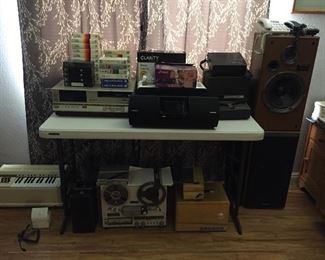Beatmax player and tapes, Technics SB-CR33 speakers, GE pump organ, Bell & Howell super 8 cameras and projectors.