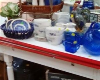 Lots of cobalt blue vintage glass, awesome enamel-topped table, old soda fountain chair, side table, Big Red wooden crate.