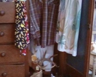 Western clothing, boots, ties, belts, and hats displayed in lovely wardrobe.