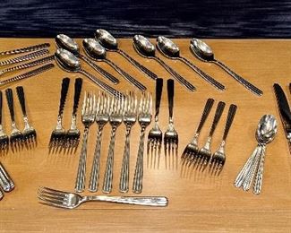 Item 58:  J. Couzon France Silverware:   $145                                                                10 dinner forks, 10 knives, 6 salad forks, 11 soup spoons, 3 teaspoons