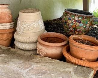 Assorted terracotta planters are priced at the sale!