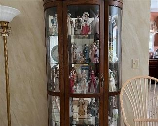 Curved lighted curio with Avon dolls