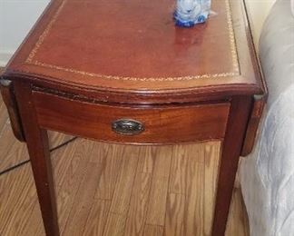 Pair of leather top end tables with fold up sides