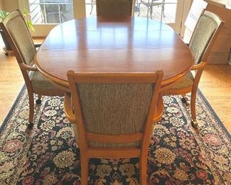 Thomasville Cherry 46" Round Pedestal Table with 4 Armed Chairs on Casters.  Expands (As Shown with 18" Leaf) to 64" Oval Table