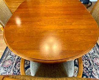 Thomasville Cherry 46" Round Pedestal Table with 4 Armed Chairs on Casters.  Expands (As Shown with 18" Leaf) to 64" Oval Table