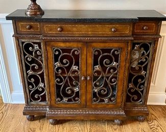 Beautiful Console with Wrought Iron Details on Doors and entire piece is wrapped in authentic leather with Stone top.  Cabinets open and 3 drawers  