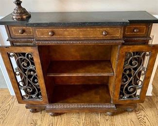 Beautiful Console with Wrought Iron Details on Doors and entire piece is wrapped in authentic leather with Stone top.  Cabinets open and 3 drawers  