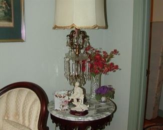 One of two marble top tables and crystal lamps