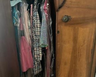 antique wardrobe with clothes