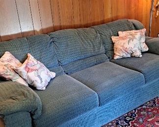 9x12 Persian Rug. Some wear.  Blue sofa. 