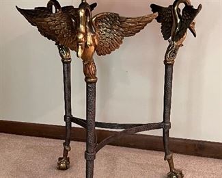 Gorgeous French Empire Style Bronze Swan and Tesselated Mosaic Stone Guerdion Table. Wow! Gorgeous triple swan guerdon accented with talon legs clutching ball feet.  Circa 1970's. Measures about 26" h x 22.5" w. Some light fading on the top surface likely from sun exposure. Comes with a glass protective cover.