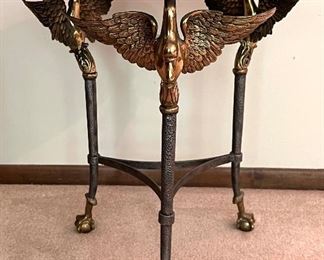 Gorgeous French Empire Style Bronze Swan and Tesselated Mosaic Stone Guerdion Table. Wow! Gorgeous triple swan guerdon accented with talon legs clutching ball feet.  Circa 1970's. Measures about 26" h x 22.5" w. Some light fading on the top surface likely from sun exposure. Comes with a glass protective cover.