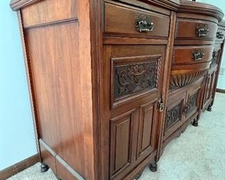 Gorgeous Antique English Edwardian Mahogany Sideboard with Carved Detailed Designs. Circa 1890-early 1900's. Truly a masterpiece! The details and design are stunning! 

Measures about 71" l x 23" deep x 96" h. 