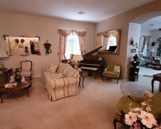 French provincial living room set with sofa, love seat, two chairs, coffee table, sofa table and lamp stands, large wall mirrors, lamps.