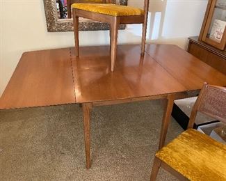 Mid-Century Modern drop leaf dining room table and 2 chairs; includes table pads.