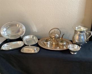 Silver Plate trays & coffee service: tray W 12" x D 9", scratched/tarnished; tray "Reed 7 Barlow 5001 Mayflower", W 10.5" x D 7.5" tarnished; tray with handle W 11" x D 6.5", tarnished; butter dish "Wm. Rogers Silverplate" with glass tray, W 8" x D 4.5", tarnished; Coffee pot, creamer and sugar bowl engraved "M" on tray, W 16.5" x D 12", tarnished; 4.5" bowl; Water pitcher, H 8.5" x W 6", tarnished.