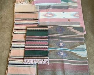 Includes (4) small rugs and (1) decorative pillow. One rug in pink, tan and green, H 64"x W 39" has a small stain, (1) runner in pink, black and green stripes, H 96"x W 27", (1) rug in pink and green, H 37"x W 22", (1) rug in pink, blue and aqua, H 56"x W 24" and (1) pillow in pastel colors, H17"x W17". No noticeable damage unless otherwise stated.