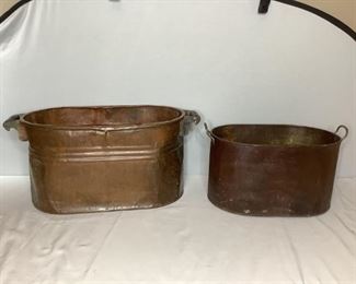 One (1) copper wash tub H 13"x W28"x D 14", with many dents and oxidation spots and (1) metal washtub H 10"x W 20.5"x D 12", labeled Fagley, with dents and rust.